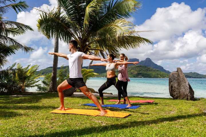 A couple doing a yoga session in Bora Bora
