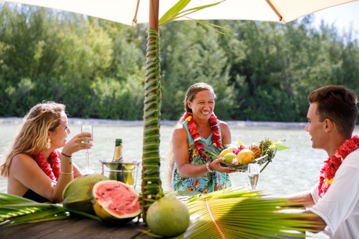 A couple having water lunch on a private island in Bora Bora
