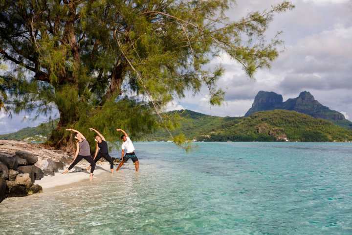 A couple doing a yoga session in Bora Bora