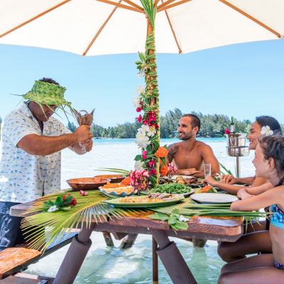 A couple having water lunch on a private island in Bora Bora
