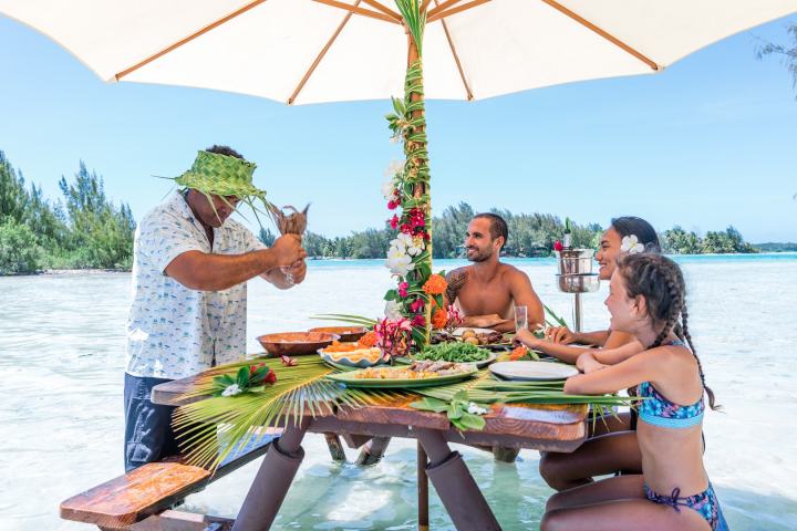 A couple having water lunch on a private island in Bora Bora