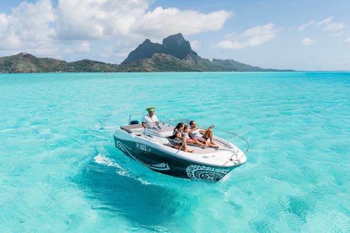 A family sailing on Bora Bora lagoon