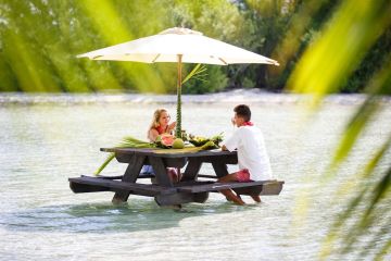 A couple having water lunch on a private island in Bora Bora